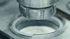 Close Up Of Automated Industrial Stainless Steel Tube Filling Milk Product In A Plastic Can. Automated Tube Machine Pouring Milk At Factory Production Conveyor Line. Automated Milk Tube Machinery
