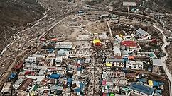 An aerial view of the crowd of devotees arriving to worship in Kedarnath Temple, a beautiful Hindu temple located in the Garhwal Himalayan range.