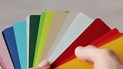 Close up on hands of man designer holding color palette at home. Male person choosing material for renovation