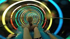 Slope down by water slide in water park. Fun travel inside of the multi color tube at aqua park filmed on action camera. Slow motion.