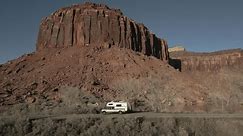Camper driving on Park Highway in Indian Creek Climbing area in Utah, USA