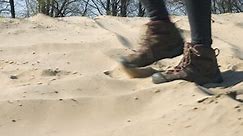 close up view of woman feet and female hikers footwear shoe walking on sand outddors adventure in the nature