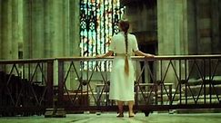 Barefoot woman wanderer looking for God in church. Adult girl with braided hair in a long dress in t