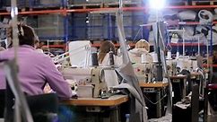Women work in a sewing workshop. Working process at a textile factory. Modern textile factory