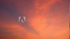 The sky transforms into a masterpiece of swirling clouds ablaze with the fiery palette of a setting sun in this stunning time-lapse. Horizon background. Natural cycles concept. Sunset timelapse. 4K.