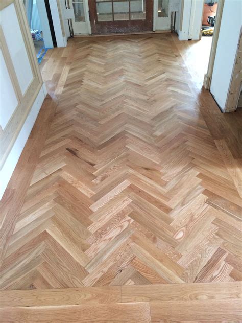 2 1/4" white oak hardwood flooring in a herring bone pattern with a 3-4 ...