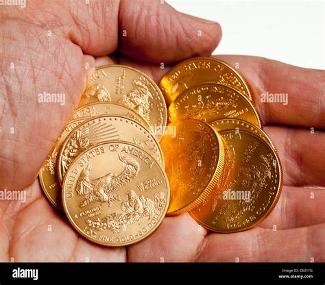 Gold Eagle one ounce coins in a stack in the palm of a hand Stock Photo ...