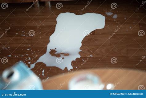 Spilled milk on the floor stock photo. Image of drop - 298503262