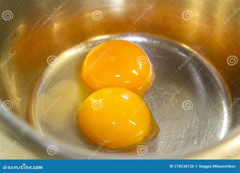 Two Egg Yolks in a Steel Bowl for Making Sauce or Omelet Stock Photo ...