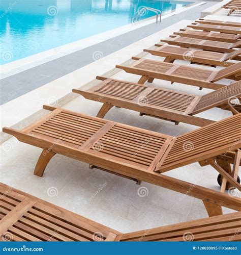 Luxury Swimming Pool with Wooden Deck Chairs. Stock Image - Image of ...