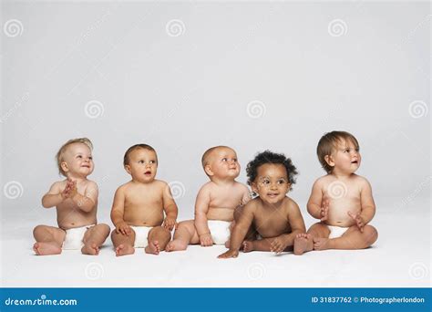 Babies Sitting Side by Side Looking Away Stock Photo - Image of ...