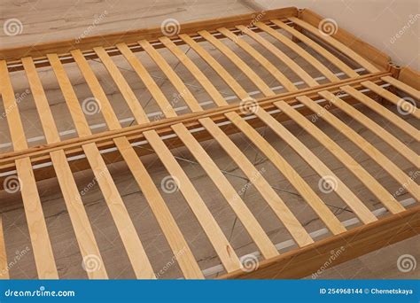 Wooden Bed Frame on Floor in Room, Closeup View Stock Photo - Image of ...