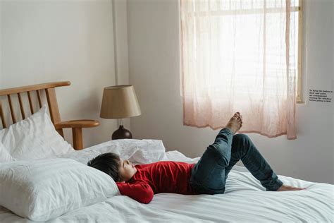 Photo of Boy Lying Down on Bed · Free Stock Photo
