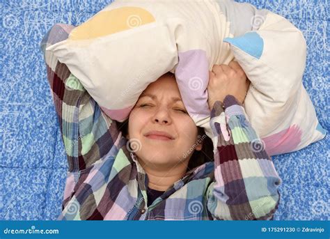 Woman with Headache Lying Down on Her Back in Bed with Pillow Over Her Head Stock Photo - Image ...