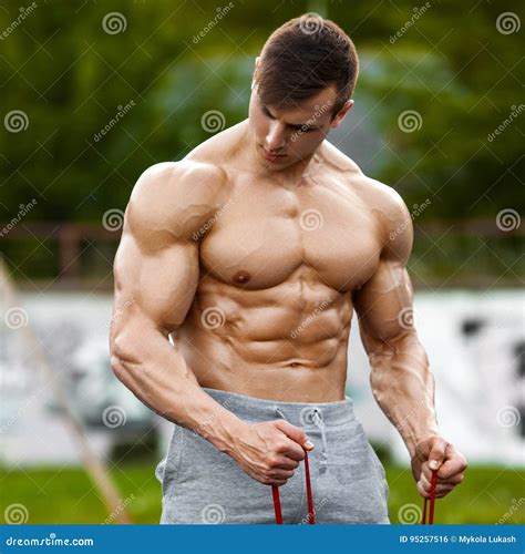 Muscular Man Working Out Outdoor, Doing Exercise. Strong Male Naked ...