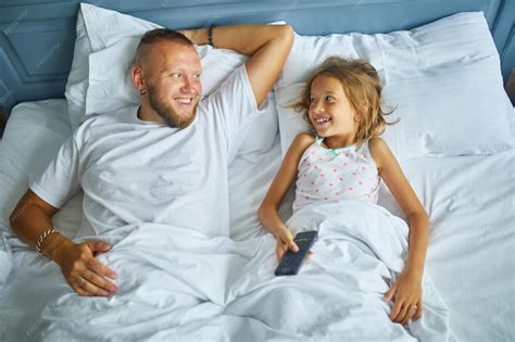 Premium Photo | Father and daughter sleeping peacefully together in a ...