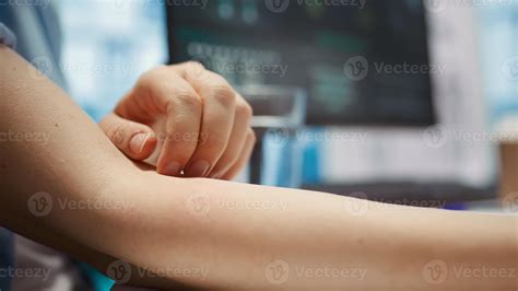 Nervous female patient with an itchy sensation feels afraid and anxious at check up visit ...