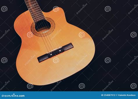 Six-string Acoustic Guitar on a Dark Brown Background. Classical ...