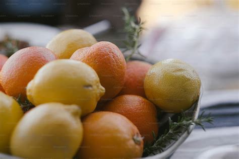 A bowl of oranges and lemons on a table photo – Los angeles Image on ...
