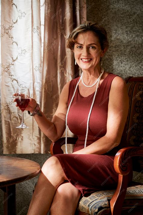 Premium Photo | Portrait of happy elegant mature woman with pearl necklace enjoying glass of red ...