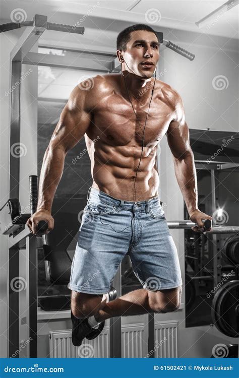 Muscular Man Working Out in Gym Doing Exercises on Parallel Bars ...