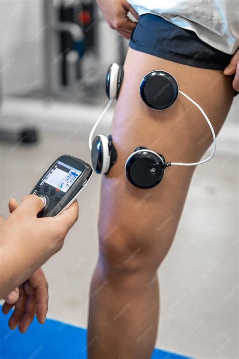 Premium Photo | The procedure of myostimulation on the legs of a woman