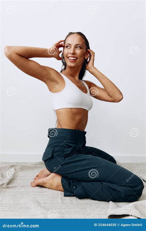 Woman Poses Sitting on Her Knees on the Floor with Beautiful Tanned ...