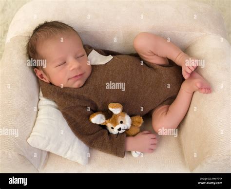 One week old newborn baby of mixed race relaxing on a soft couch Stock ...