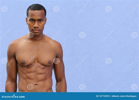 Under the Sunshine, a Masculine Black Guy, Half Naked, is Standing by ...