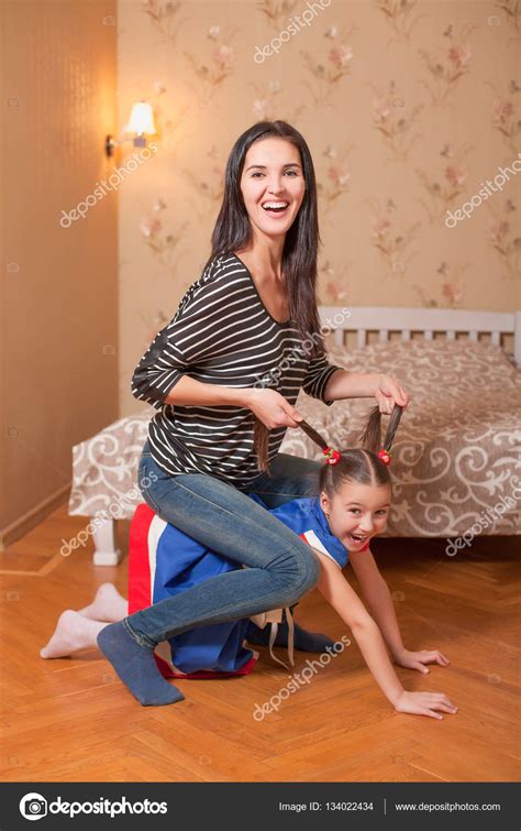 Mother sitting on back of little daughter Stock Photo by ©Nomadsoul1 134022434
