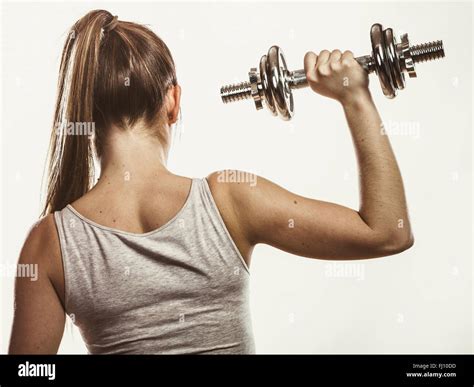 Strong woman lifting dumbbells weights. Fit girl exercising gaining ...