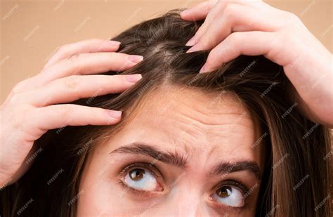 Premium Photo | Close up of woman examining her scalp and hair hair ...