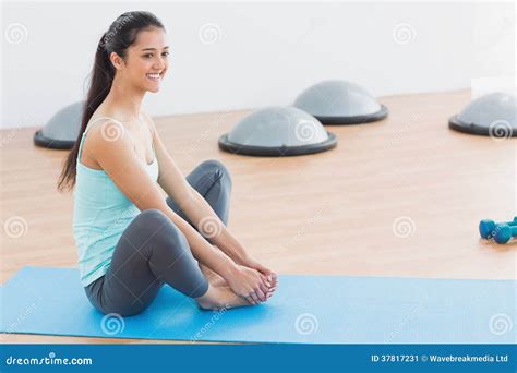 Smiling Fit Woman Doing the Butterfly Stretch in Exercise Room Stock ...