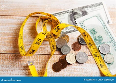 Measuring Tape, Coins and Dollar Bills on the Table Stock Photo - Image of business, bill: 233882352 - measurement of dollar bill