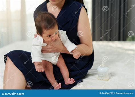 Mother Holding Newborn Baby Burping in Bedroom after Feeding Milk Stock ...