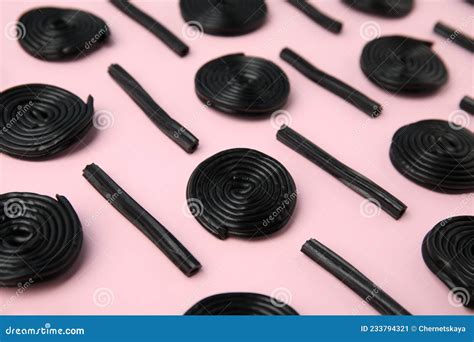 Tasty Black Liquorice Candies on Pink Background Stock Image - Image of ...