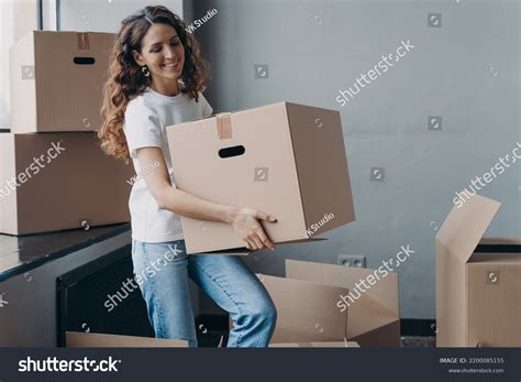 Smiling Spanish Woman Volunteer Carrying Cardboard Stock Photo ...