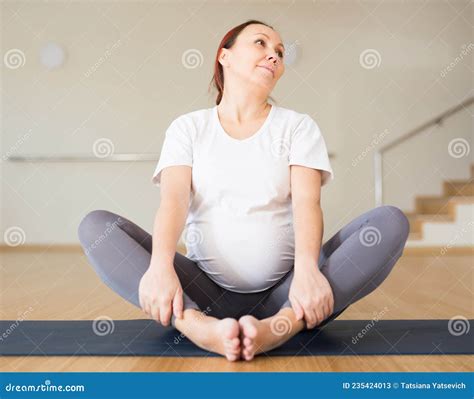 Pregnant Woman is Engaged in Yoga. Butterfly Pose or Baddha Konasana ...