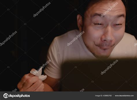 Funny horny face of man watching porn at night. Stock Photo by ...