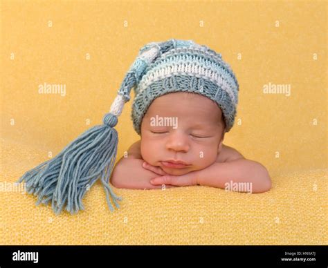 One week old newborn baby of mixed race sleeping on a soft yellow ...