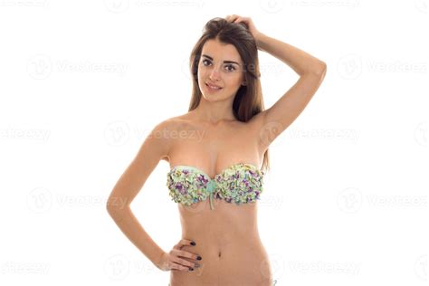 a young girl in a bathing suit with beautiful breasts keeps his hand on the side and the second ...