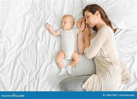 Mother and Her Adorable Newborn Baby Sleeping in Bed Together Stock ...