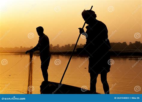 Silhouette of fishermen editorial stock photo. Image of water - 263104003