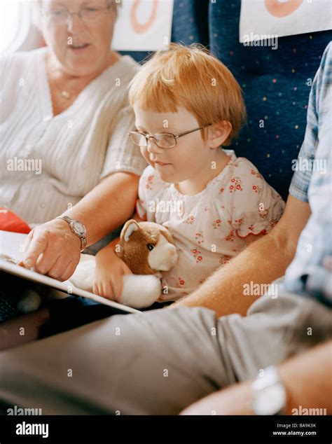 Grandmother and granddaughter reading a book in a train, Sweden Stock ...