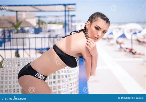 Caucasian Woman on the Beach with Black and White Swimsuit and Pigtails ...
