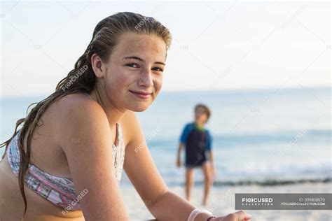 Smiling teenage girl at sandy tropical beach, Grand Cayman Island ...