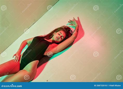 Portrait of a Tattoo Woman Wearing in a Black Bodysuit Lying on the ...