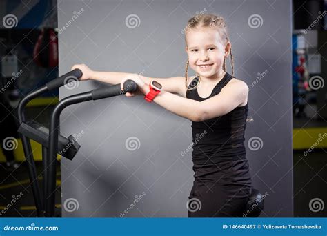 Small Attractive Caucasian Child Using Exercise Bike in the Gym ...