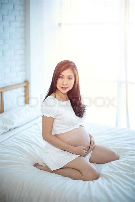 Attractive pregnant asian woman | Stock image | Colourbox