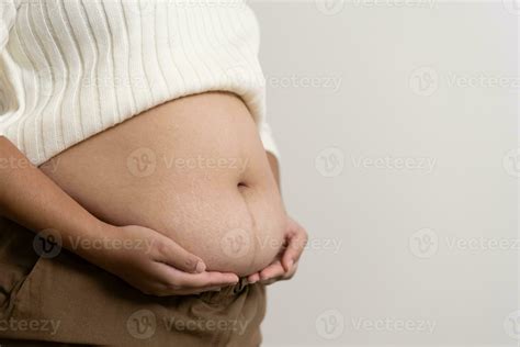 An obesity using measuring tape to show the real size. Chubby fat woman ...